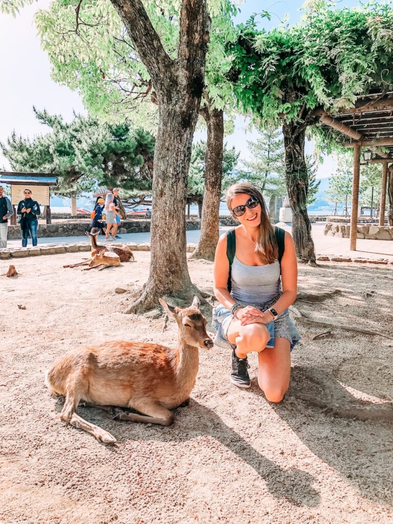 Bec, Sydney travel blogger, on Miyajima Island, Japan, meeting the local wildlife