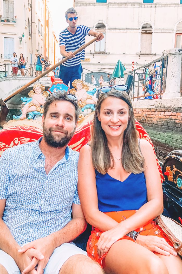 Gondola navigating the Grand Canal in Venice on a sunny afternoon
