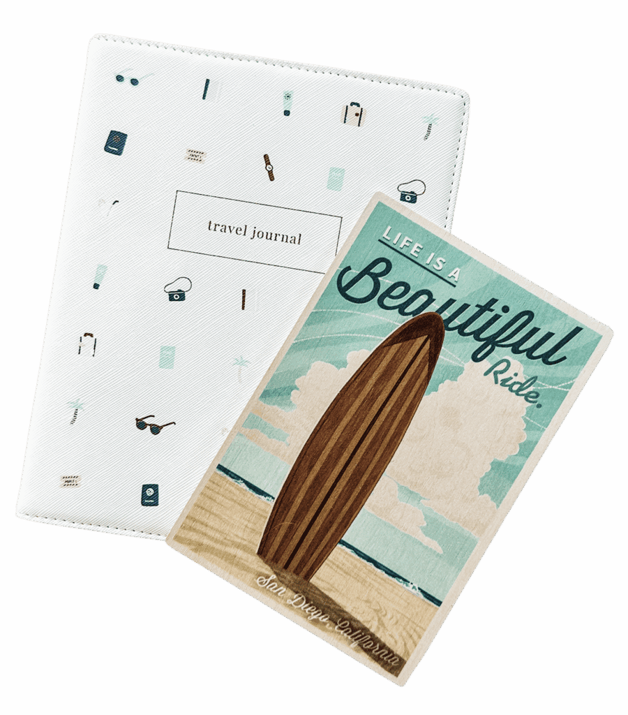 A photo of a travel journal and a retro postcard from California showing a surfboard standing on the beach