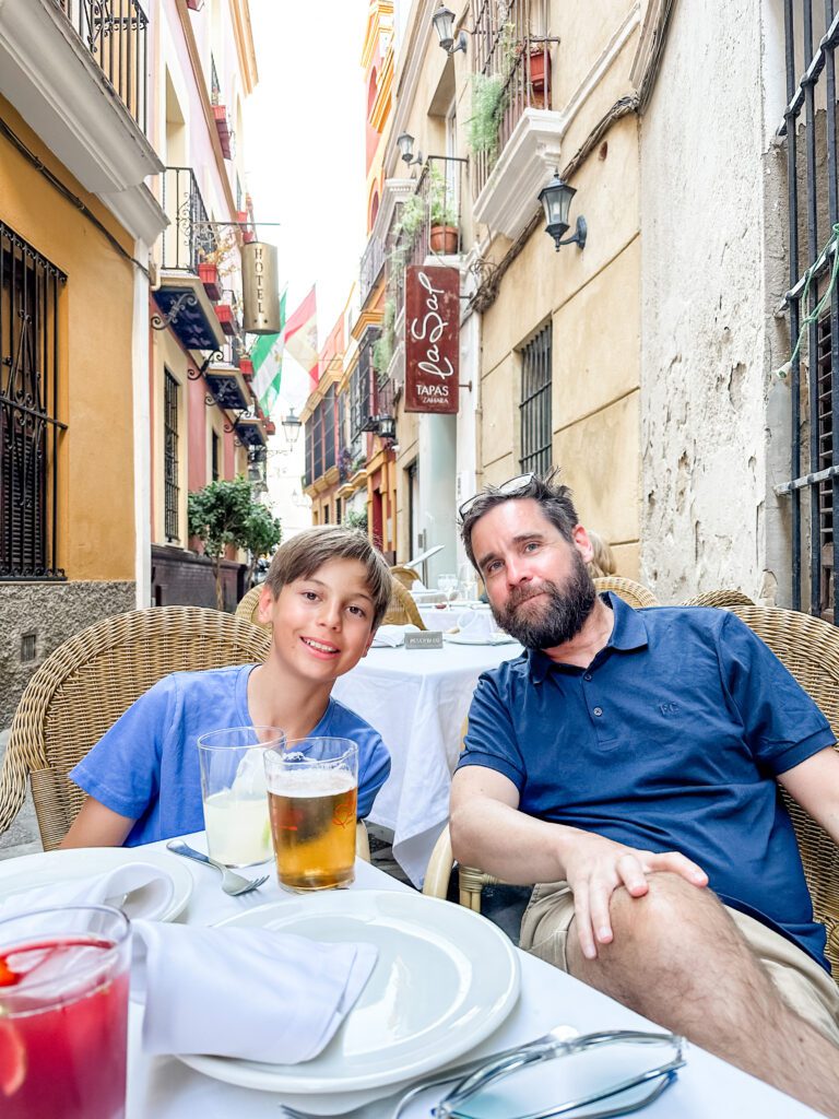 Enjoying pre dinner drinks at the dining tables outside Restaurante La Sal in Seville, Spain