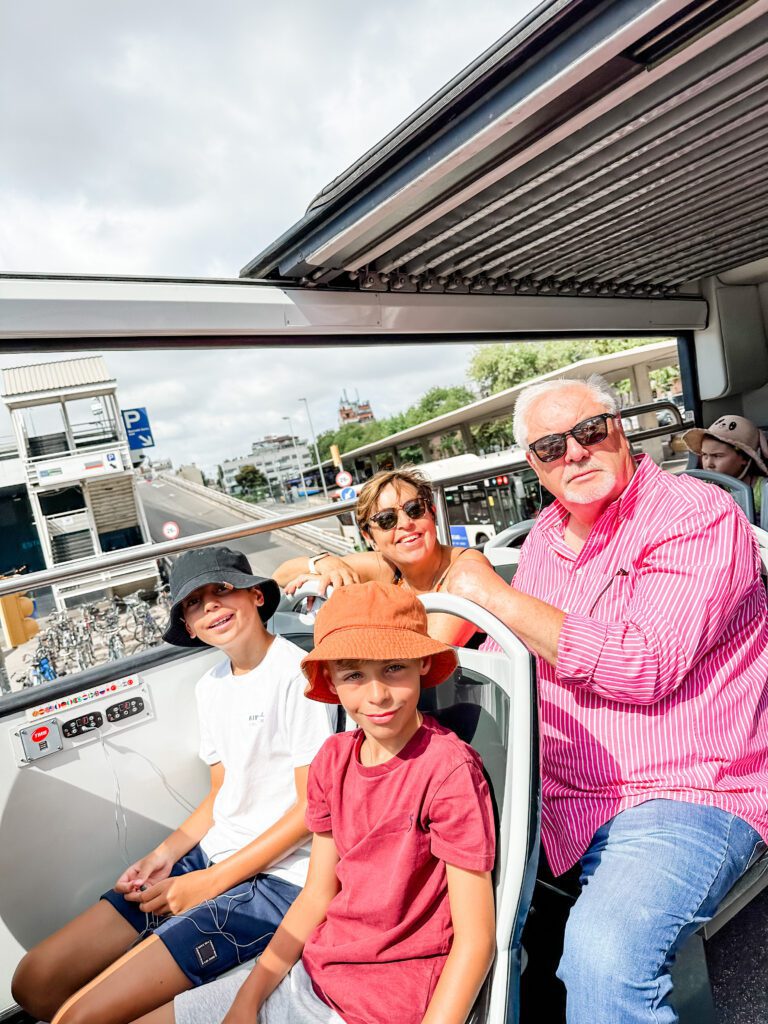 Family trip on the hop-on hop-off tourist bus in Barcelona, Spain