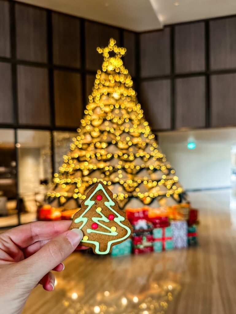 A welcome christmas cookie in front of the christmas tree made of traditional conical hats at the reception area of Crowne Plaza Phu Quoc by Starbay