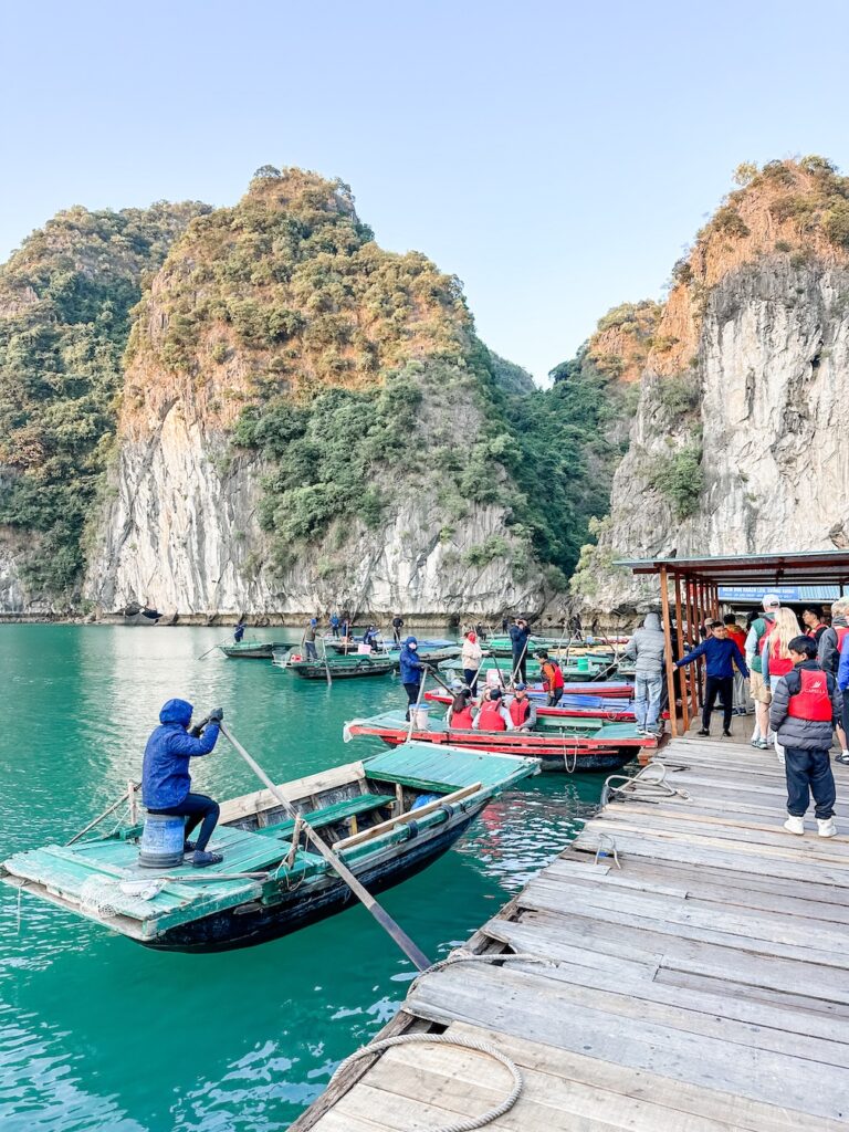 The floating village at Cura Van in Vietnam where you can see locals preparing the flat bottom boats for tourists to take for a trip around the Dark and Bright Cave in Ha Long Bay. 