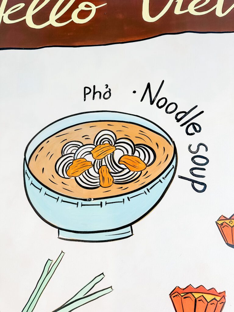 A colourful mural pained in the Cafe Apartment in Ho Chi Minh of a bowl of Pho Noodle Soup